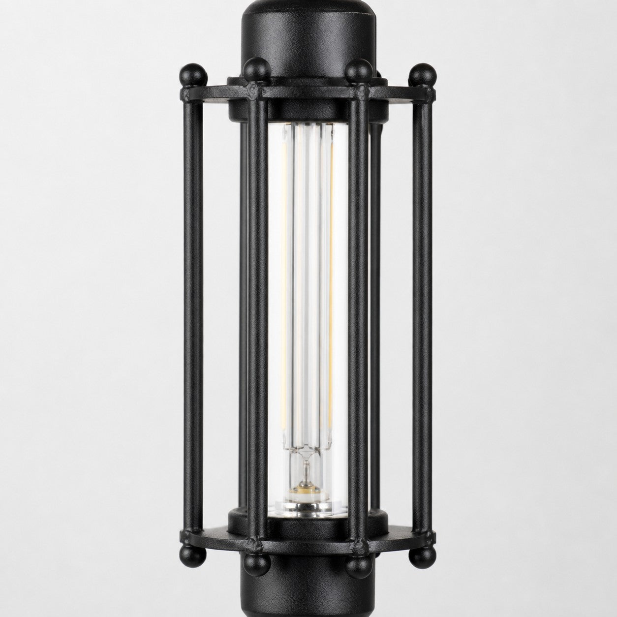 Close view of black tube guard frame and glass shade