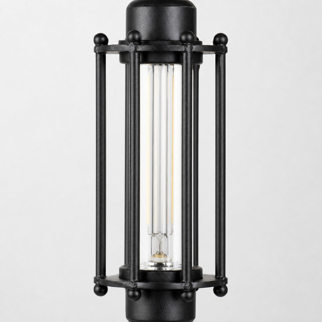 Close view of black tube guard frame and glass shade