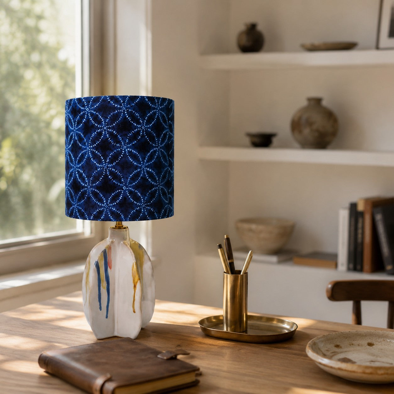 Blue patterned ceramic table lamp on a warm tabletop