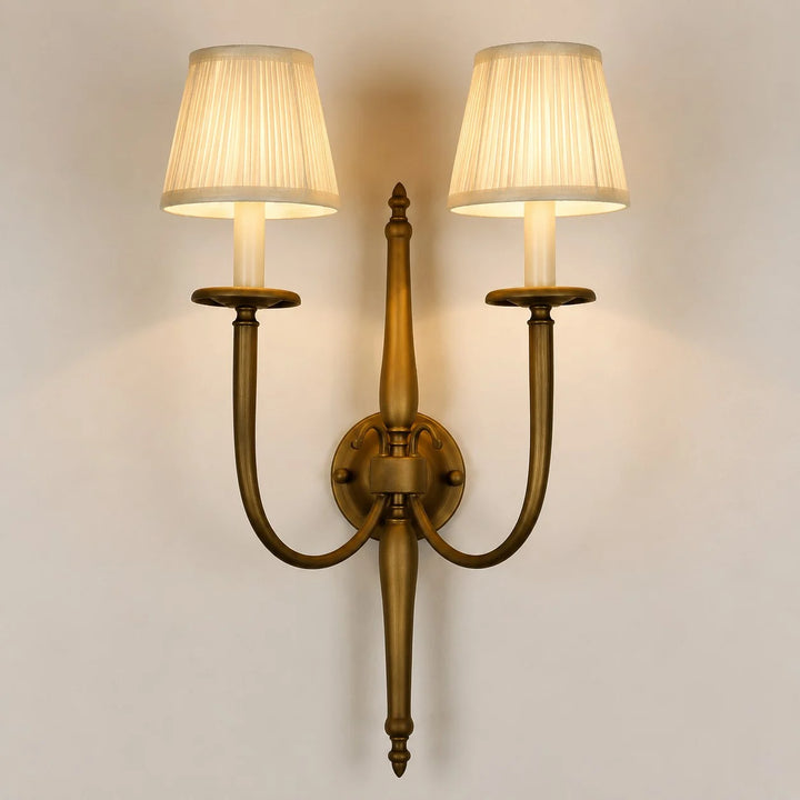 Front view of double arm wall sconce with pleated fabric shades