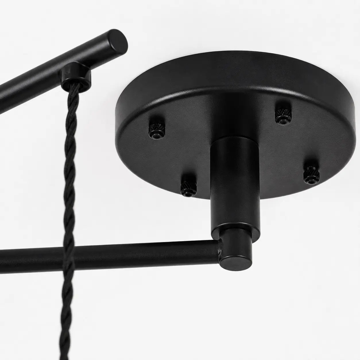 Black ceiling canopy and movable arm connection detail