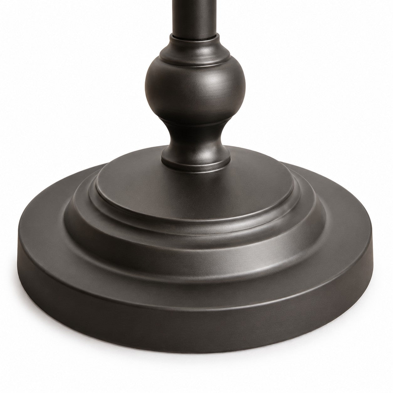 Close-up of the layered round base on the black metal floor lamp