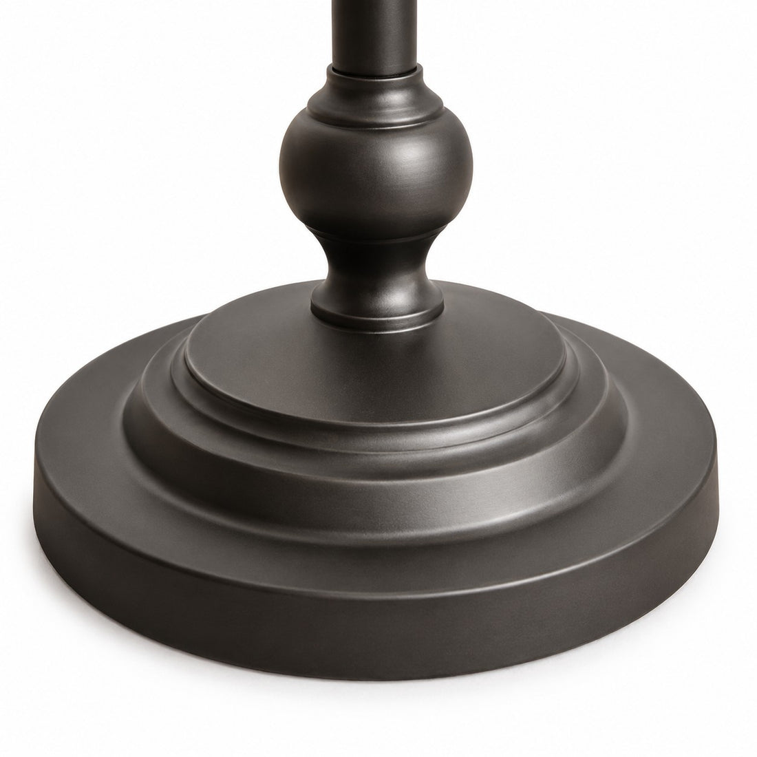 Close-up of the layered round base on the black metal floor lamp