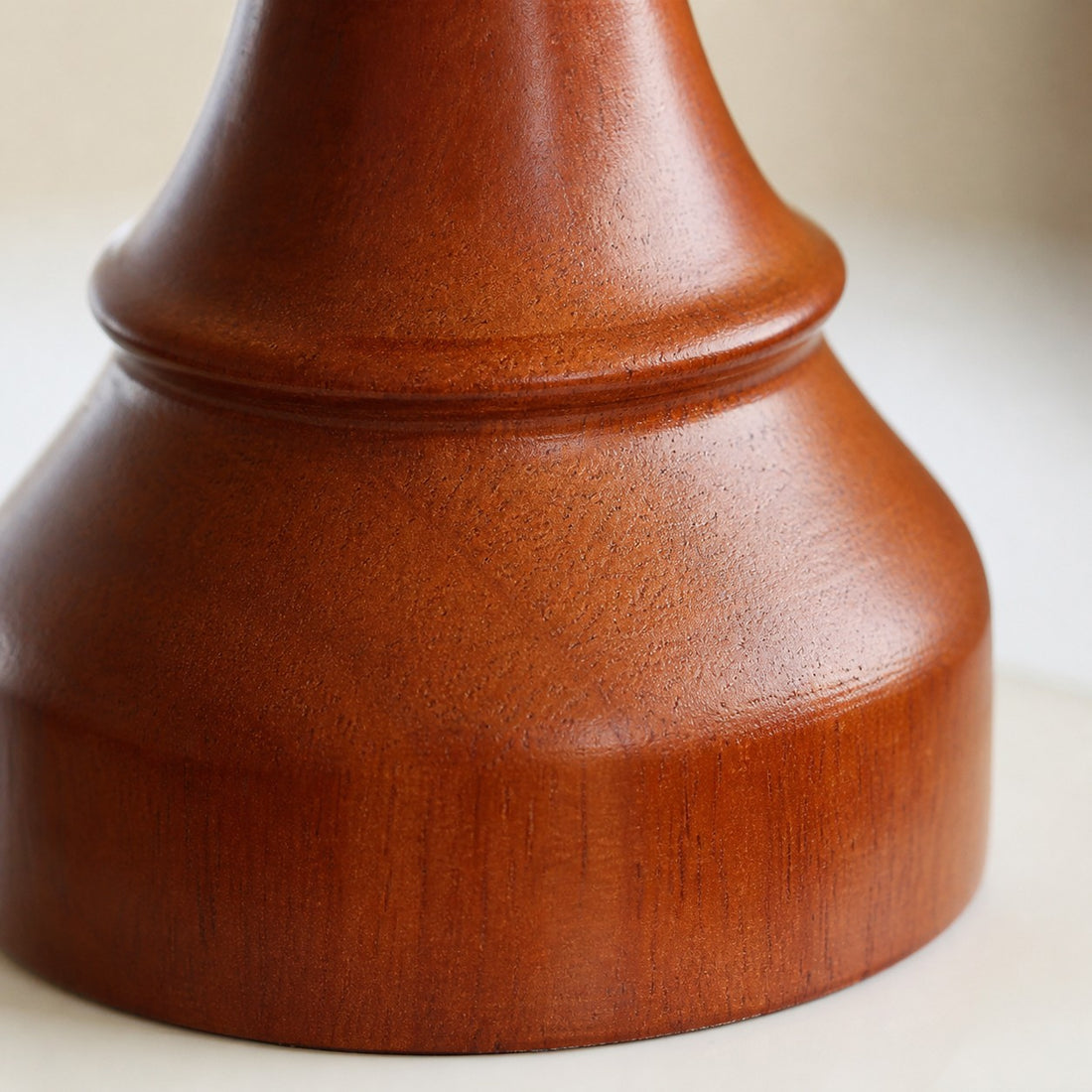 close view of polished wood connector on ceramic pendant light