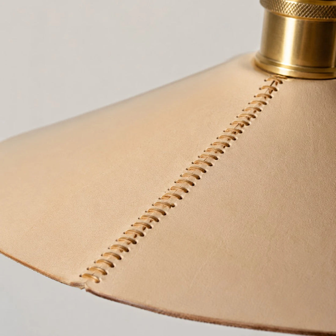 Wide detail of hand stitched leather pendant shade
