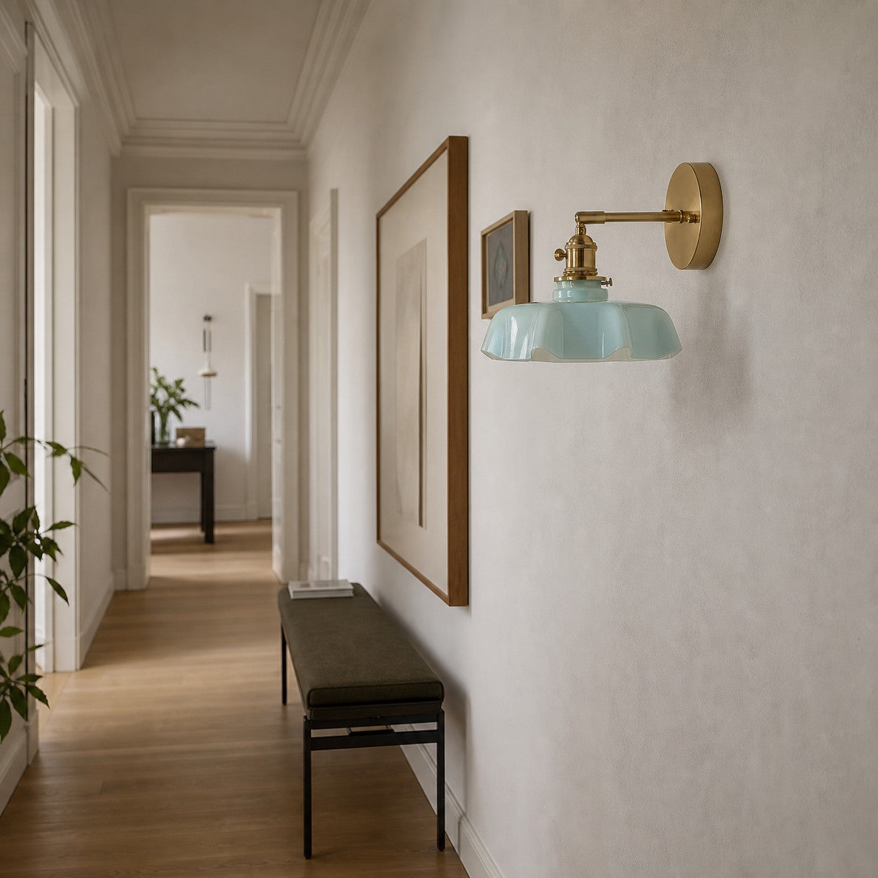 Blue milk glass brass wall sconce in a hallway