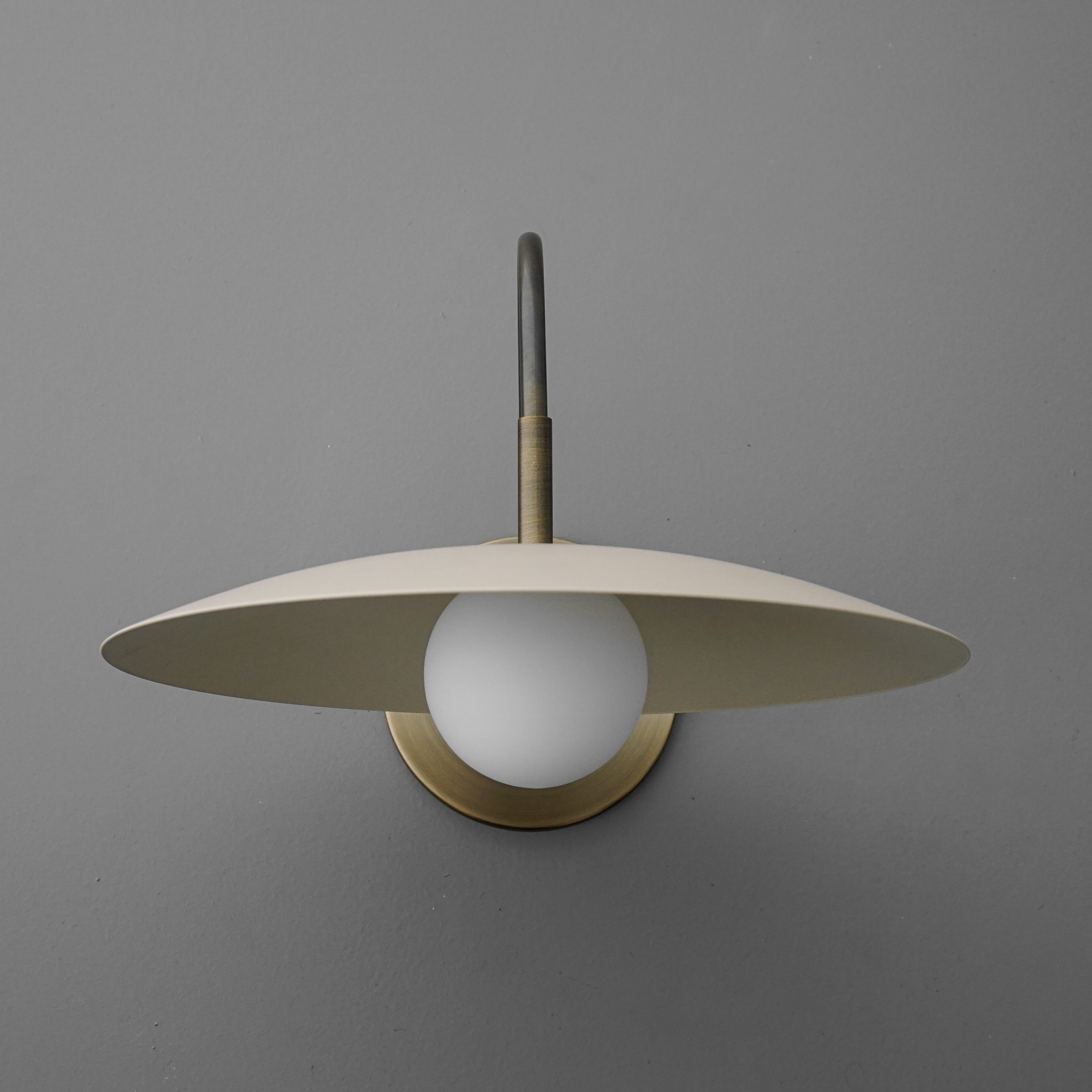 Curva Metal Modern Wall Sconce - Antique Brass Arm with Cream Disc Shade
