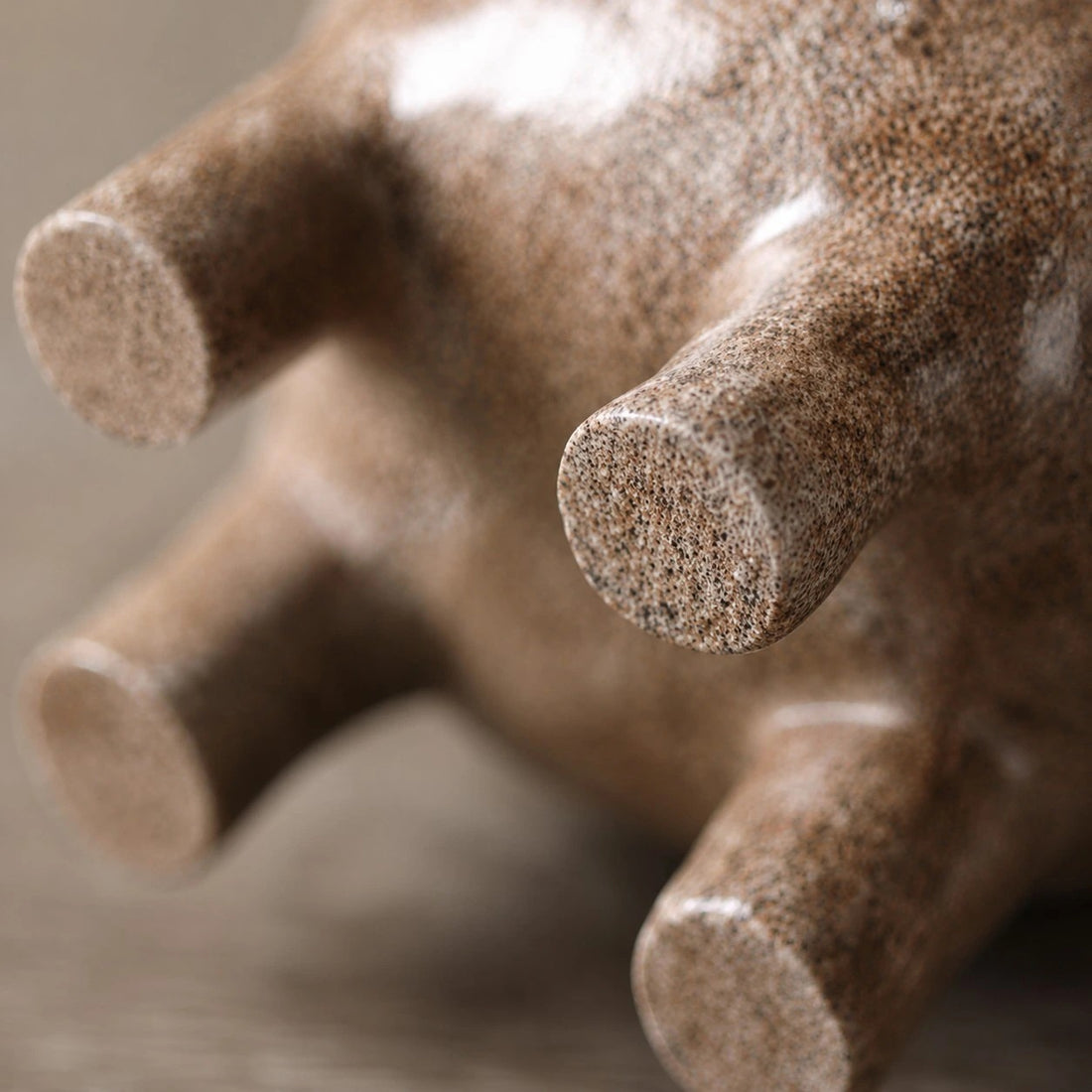 Close view of the rounded feet and speckled resin finish
