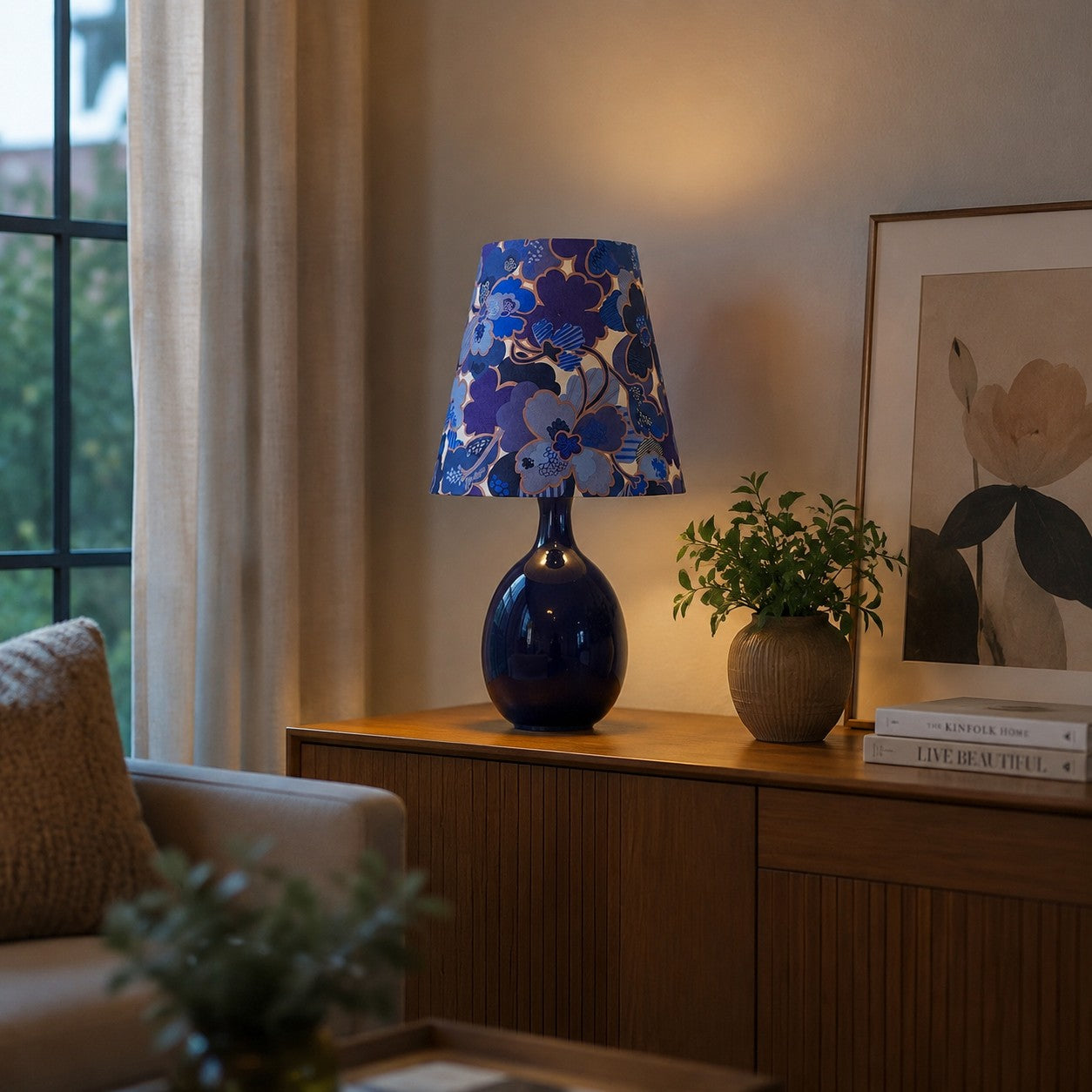 Blue floral ceramic table lamp styled near a window
