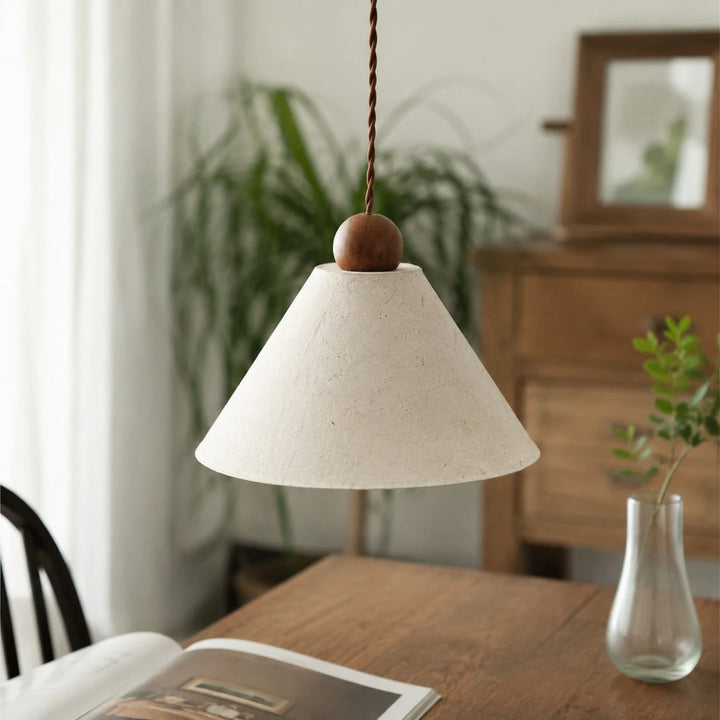 Natural paper pendant lamp over a dining table