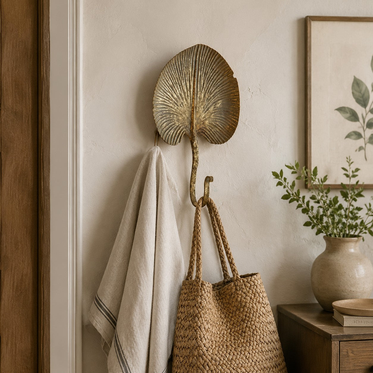 Antique-gold botanical wall hook in an entryway