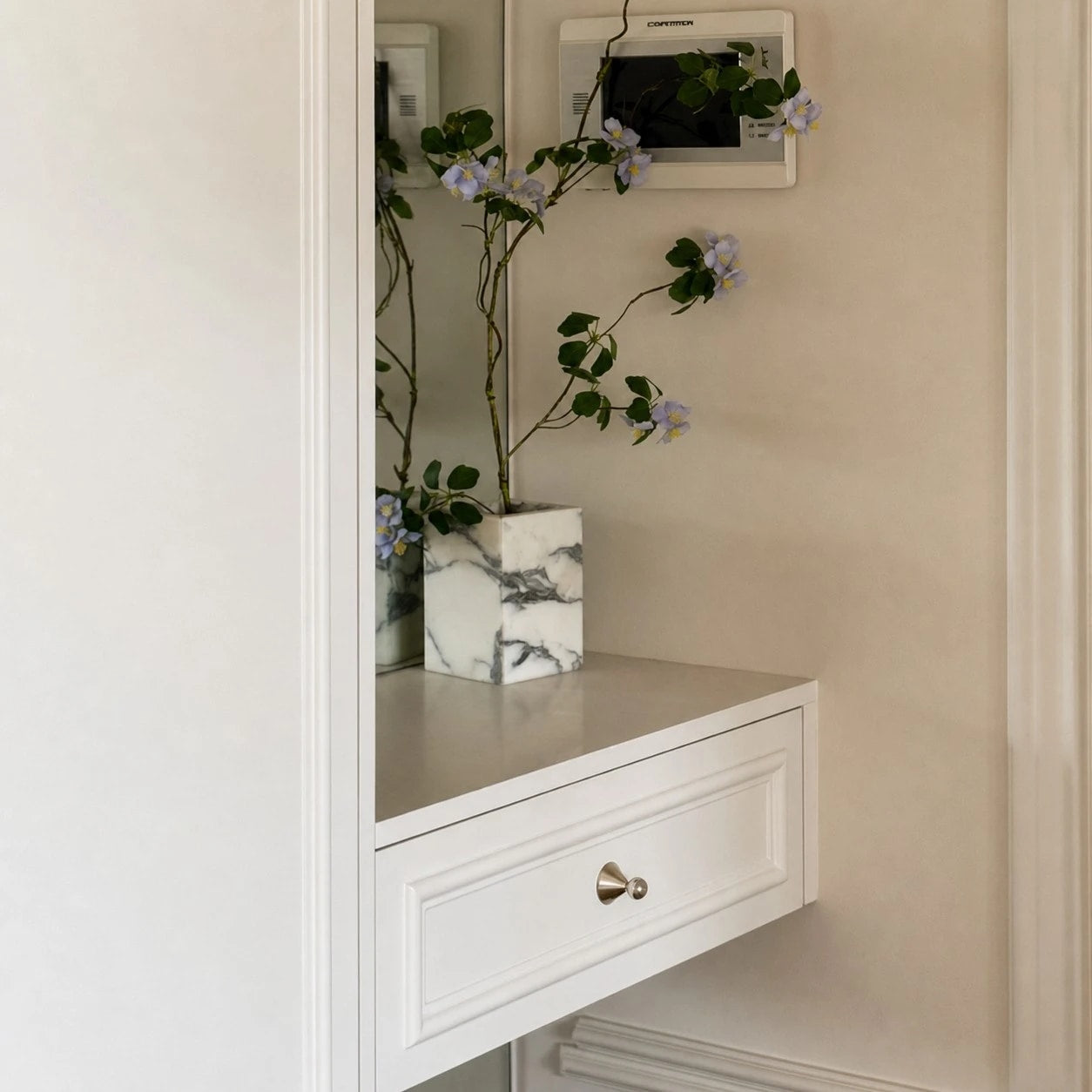 Polished cabinet knobs styled on an entryway cabinet