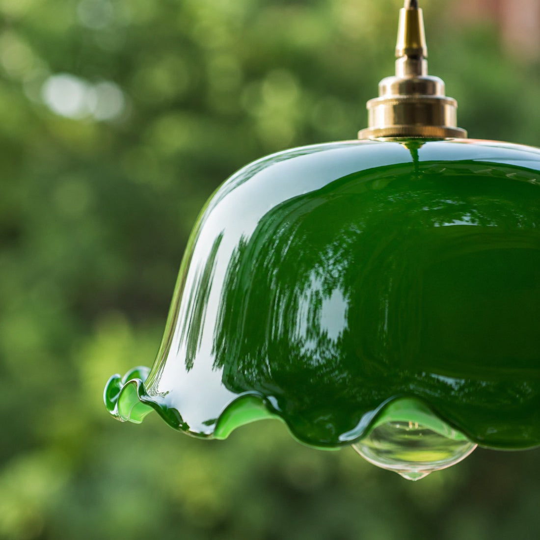 Close view of glossy green glass shade edge