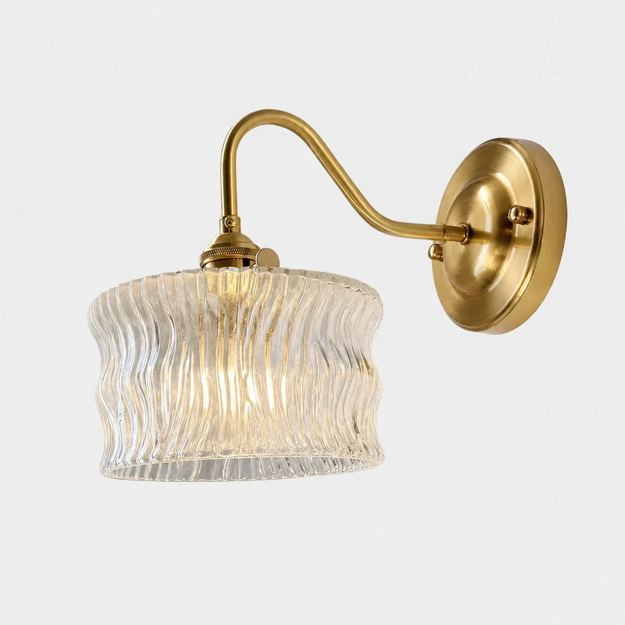 Clear ripple glass wall sconce with brushed brass arm