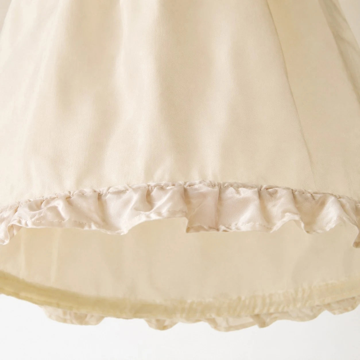 Close view of the softly ruffled fabric shade edge