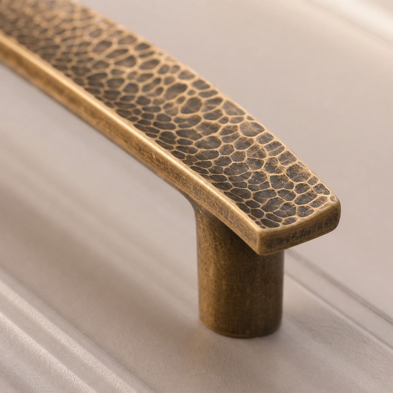 Hammered brass cabinet pull surface texture