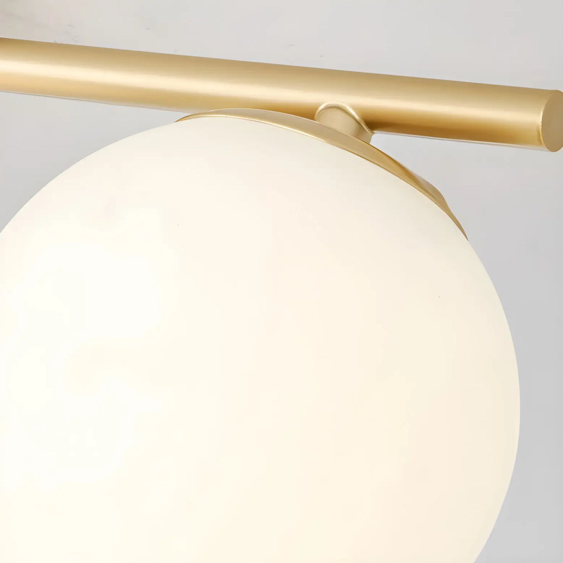 Gold metal bar and milk glass shade detail