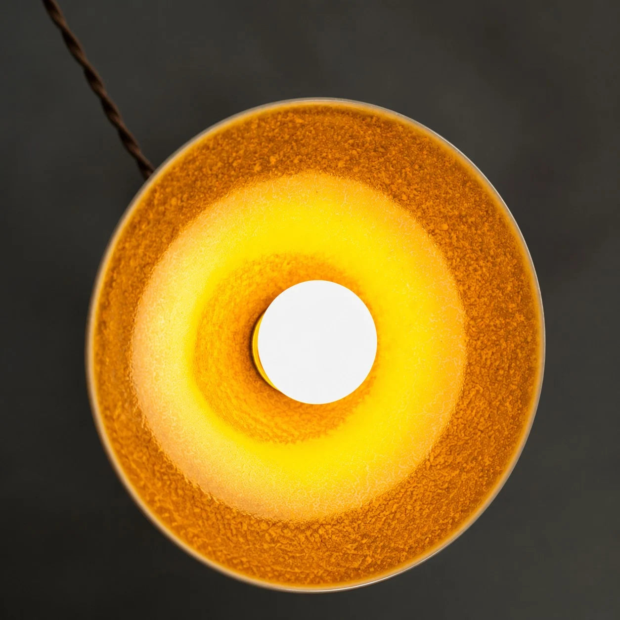 Underside view of the yellow ceramic glaze and open bulb area