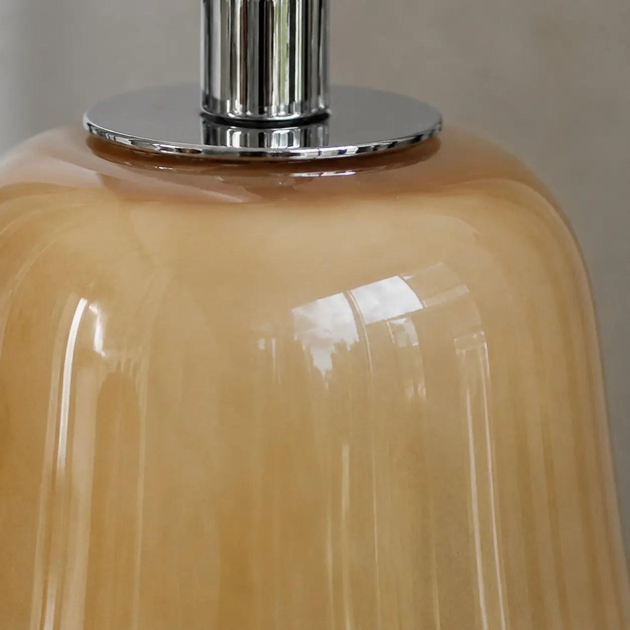 Chrome-finish top connector on the glass shade