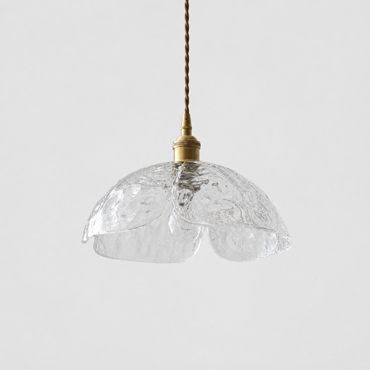 Single clear pressed-glass flower pendant with brass socket