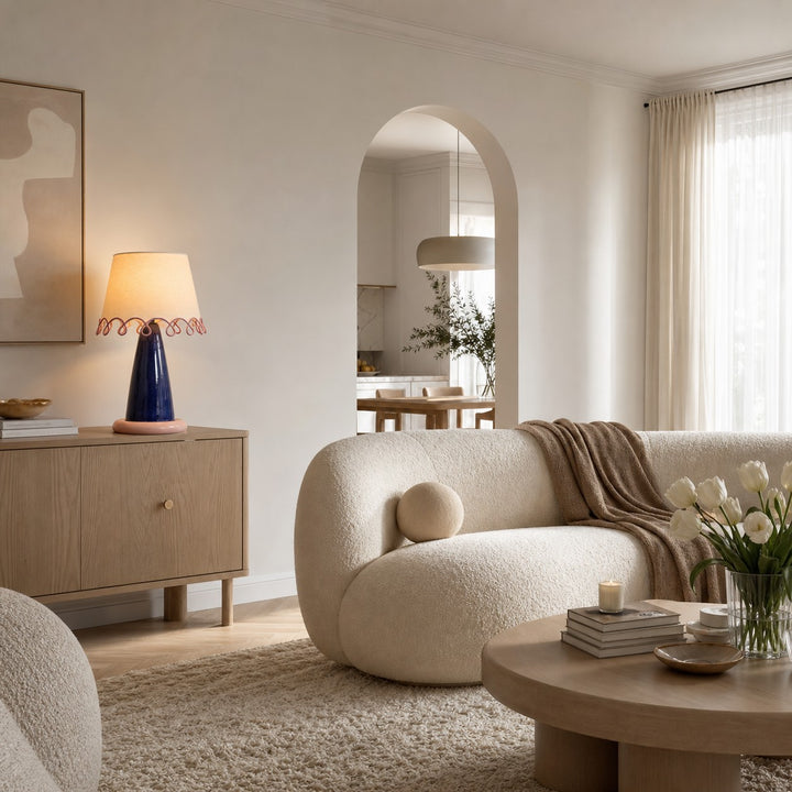 Sculptural ceramic table lamp on a sideboard in a neutral living room