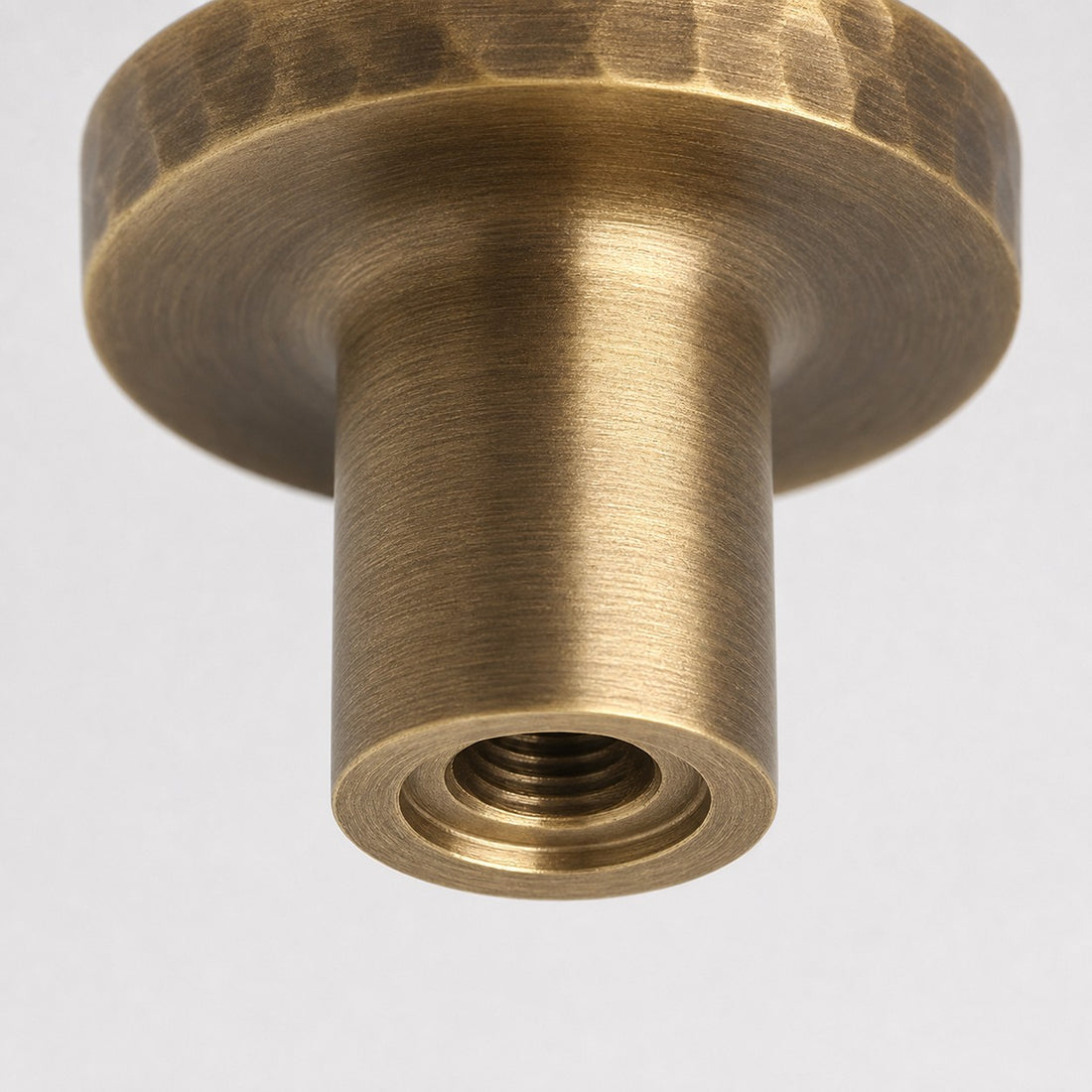 Close view of threaded mounting hole on antique brass knob