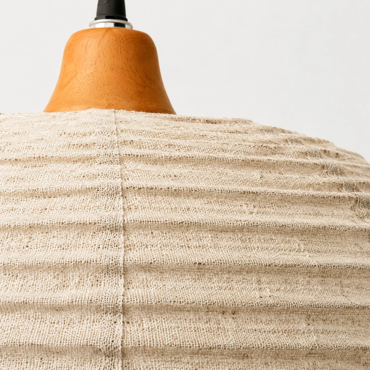 Close view of the fabric shade and wooden top detail