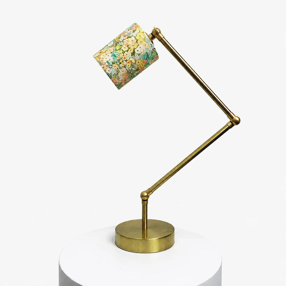 Adjustable brass-tone table lamp with cream garden floral fabric shade
