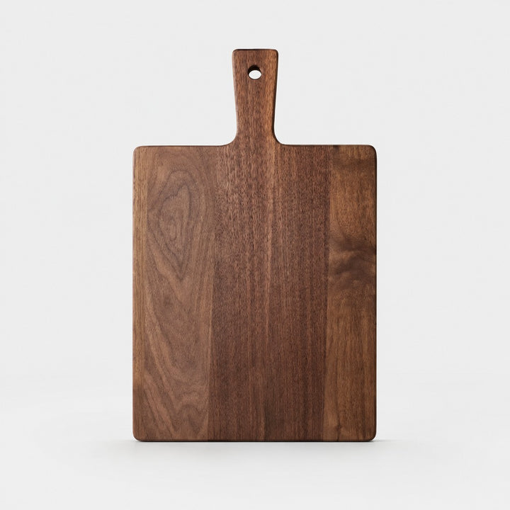 Large black walnut cutting board on a light background