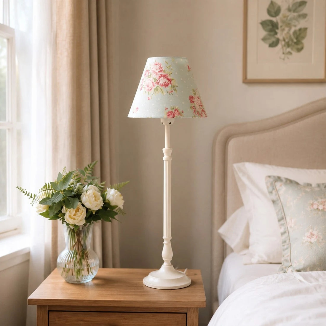 Blue floral French country table lamp beside a bed