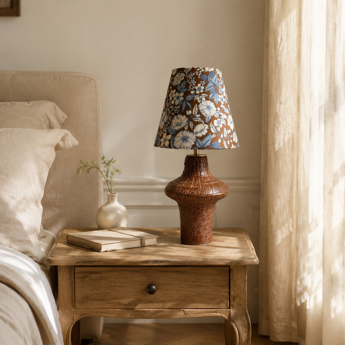 Blue floral ceramic table lamp on a bedside table
