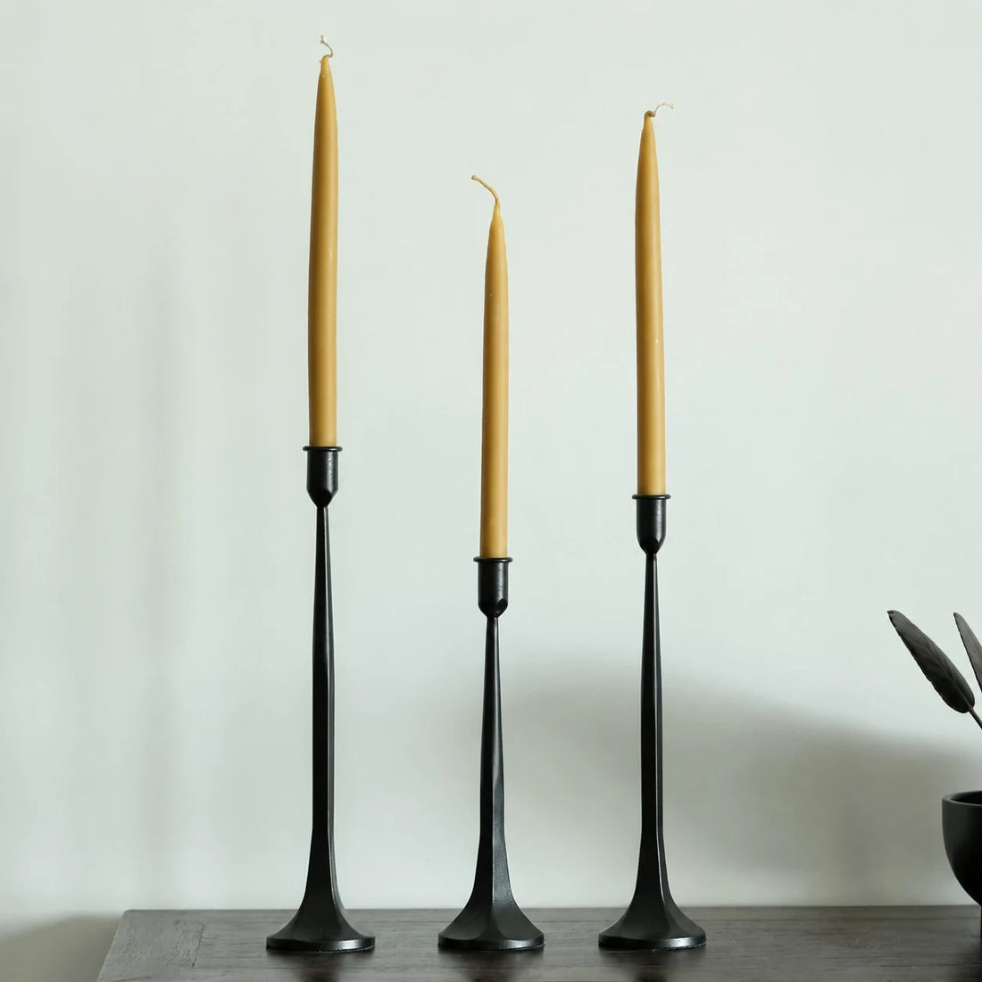 Three-piece black iron candle holder set styled with customer-supplied taper candles; candles not included