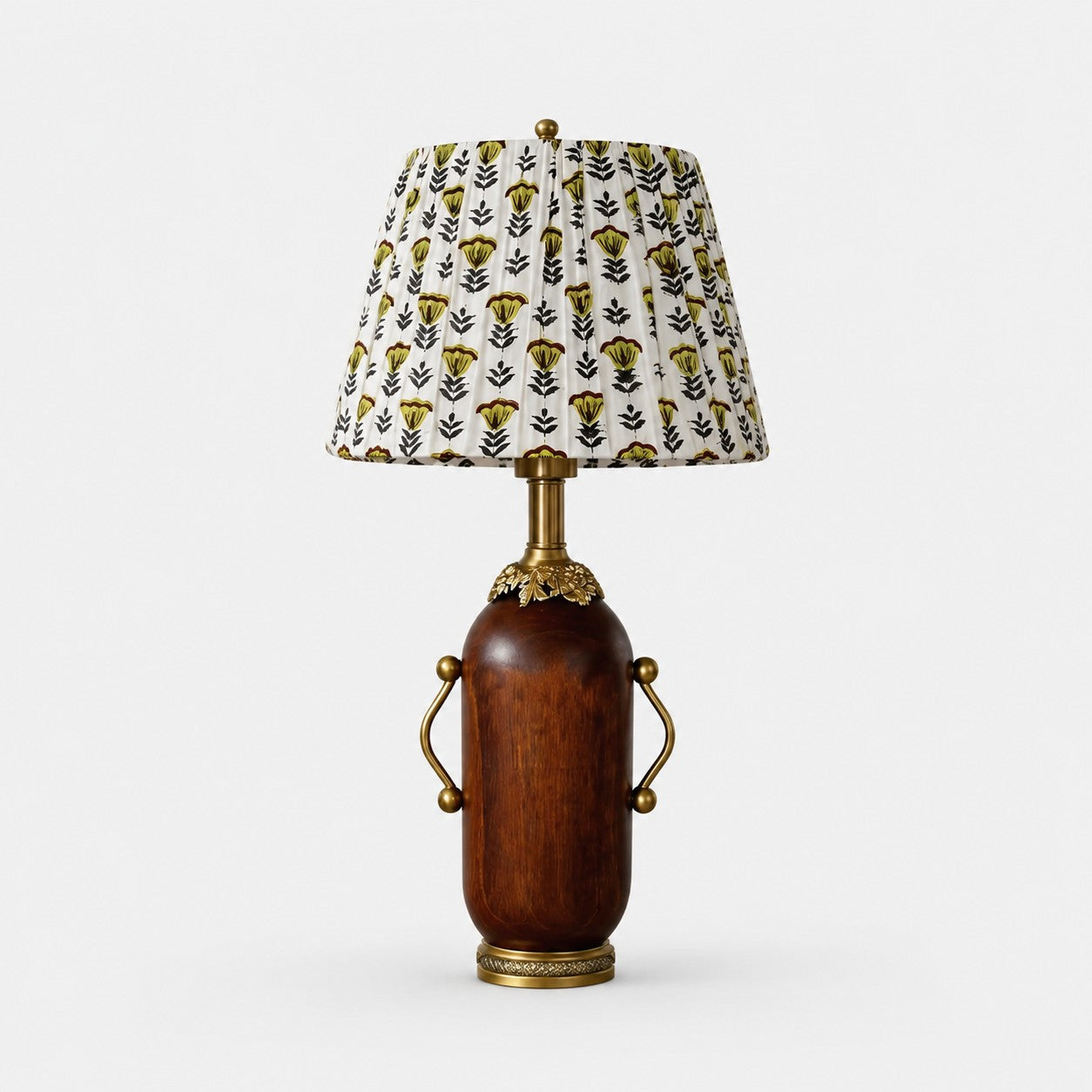 Deep brown vintage table lamp with yellow floral pleated shade on white background