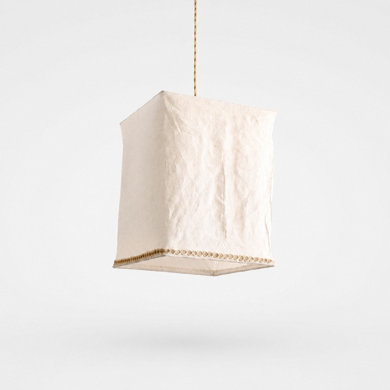 Sculptural linen pendant light on a clean light background