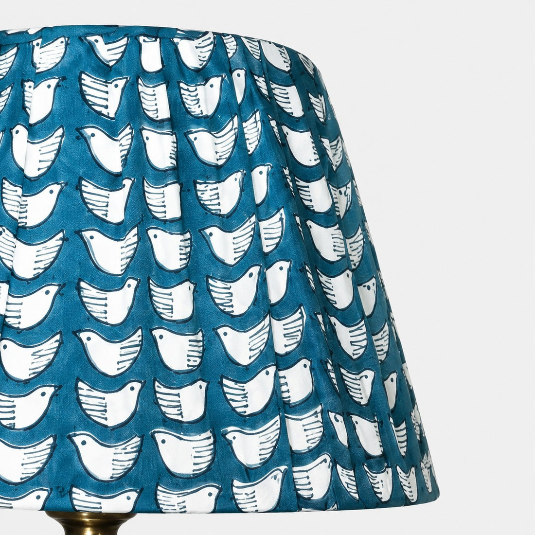 Teal pleated fabric shade with white bird pattern detail