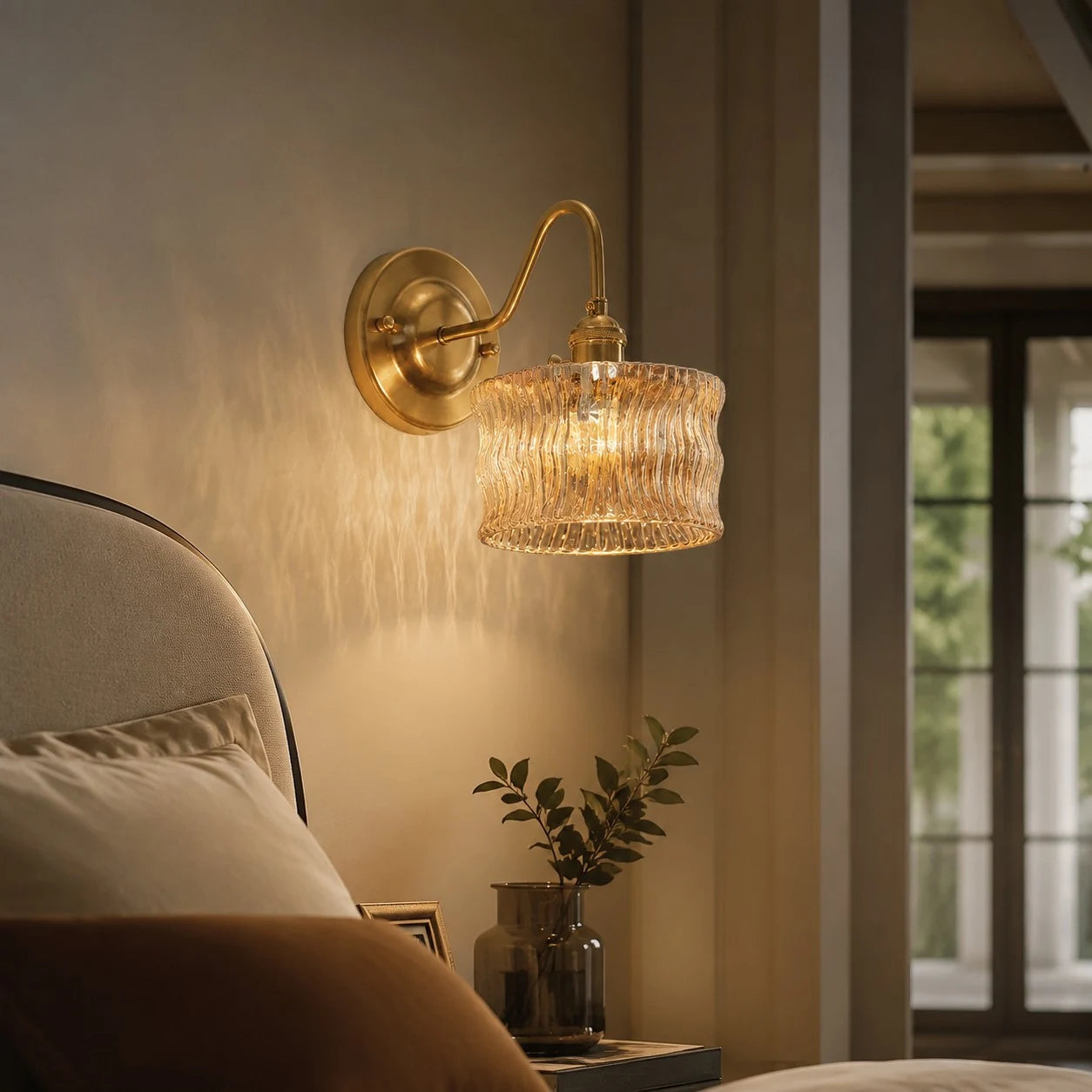 Amber ripple glass wall light casting warm bedside texture