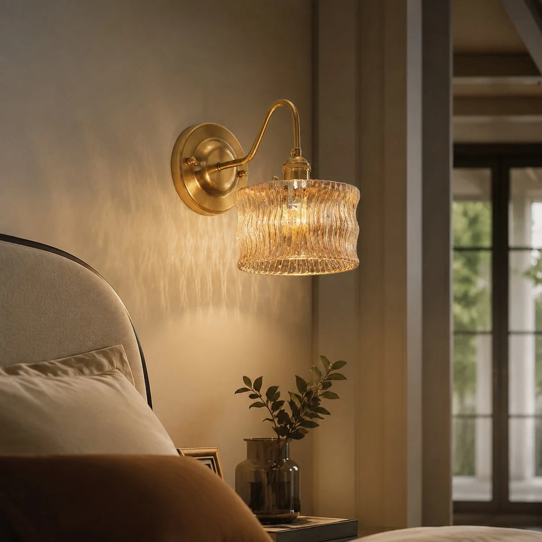 Amber ripple glass wall light casting warm bedside texture