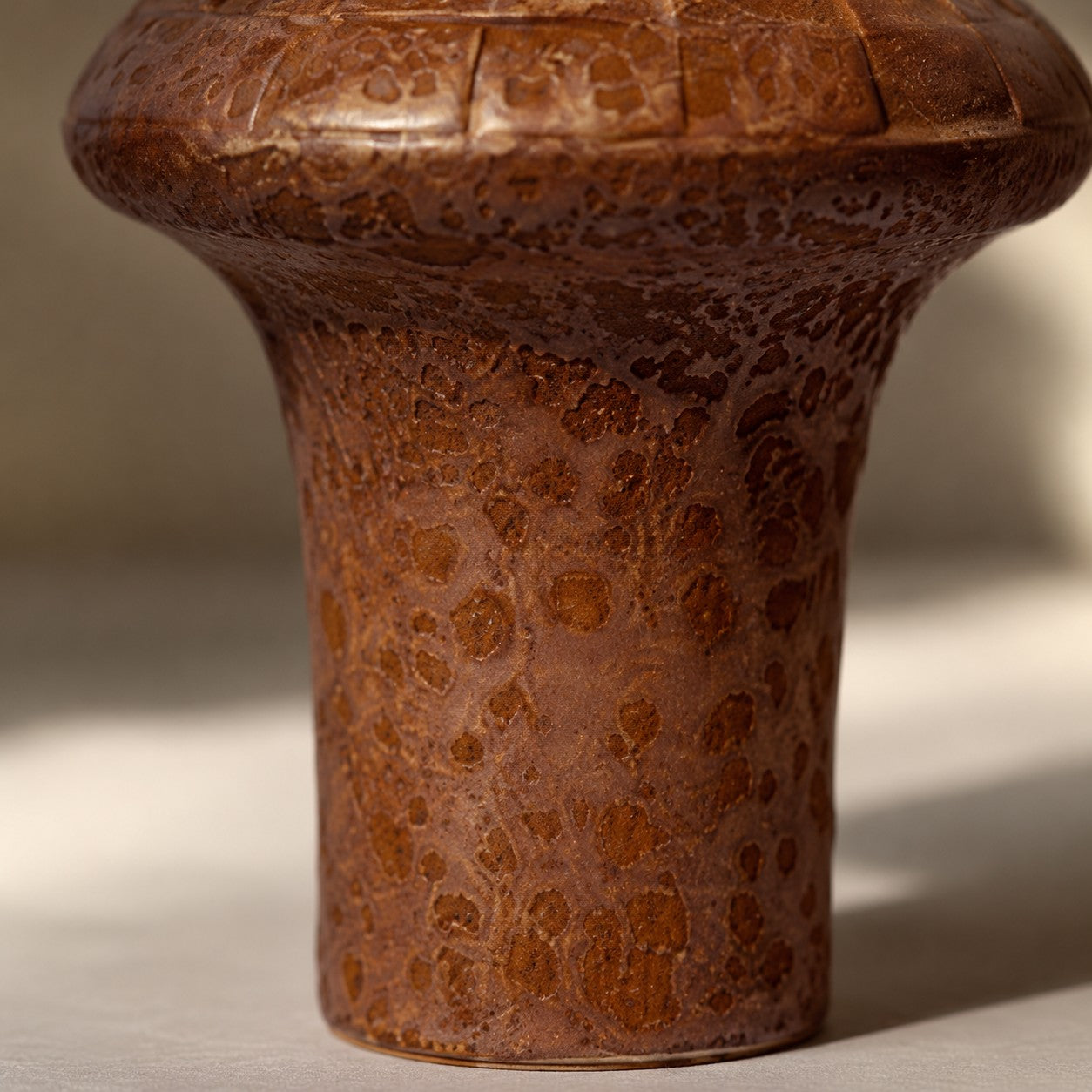 Close view of warm brown ceramic lamp base texture