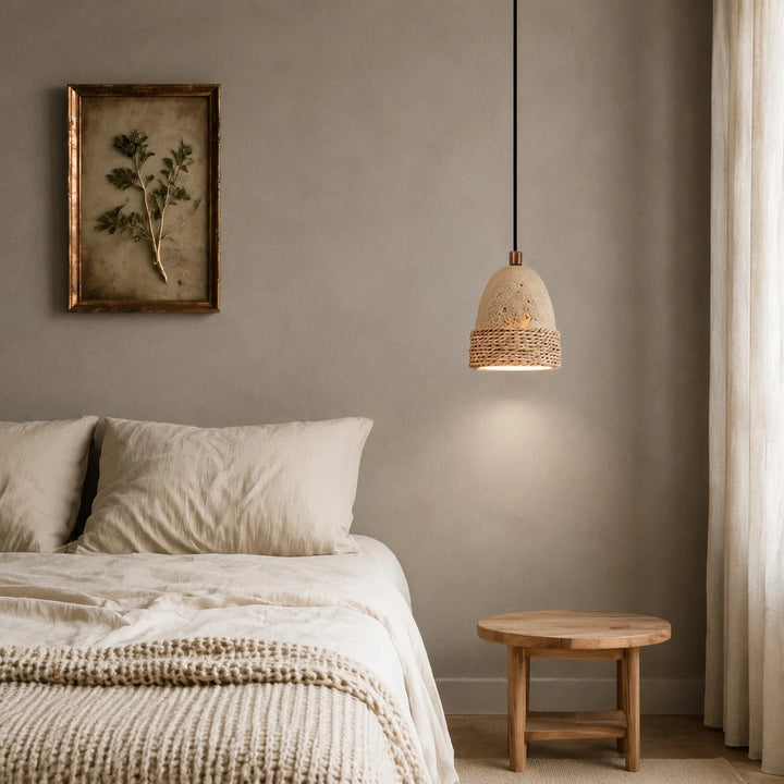 Wabi-sabi woven stone pendant light installed beside a bed