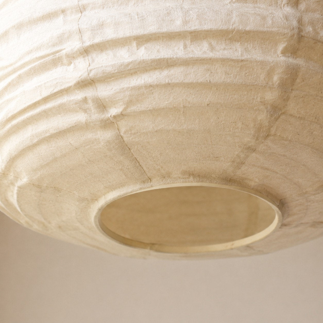 Close view of the underside opening of the linen pendant shade