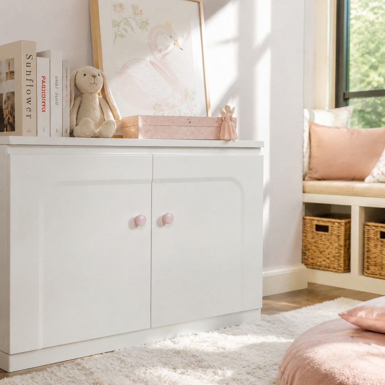 Blush pink cabinet knobs in a bright bedroom