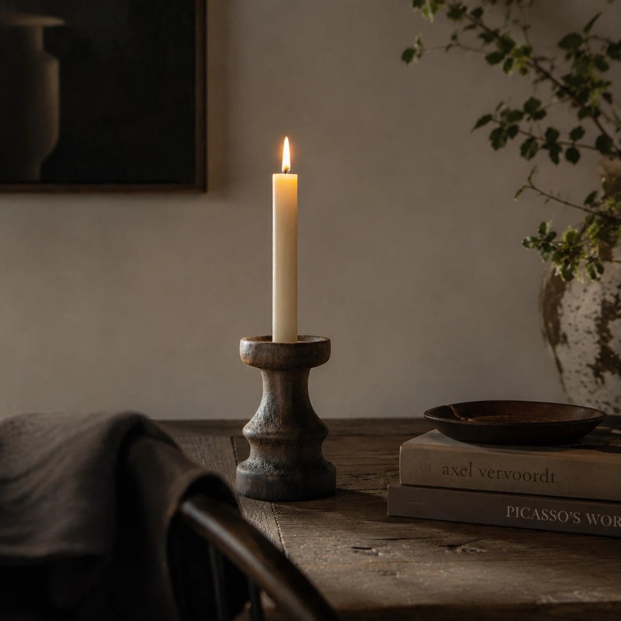 Solid wood candle holder with a taper candle in a dining setting; candle not included