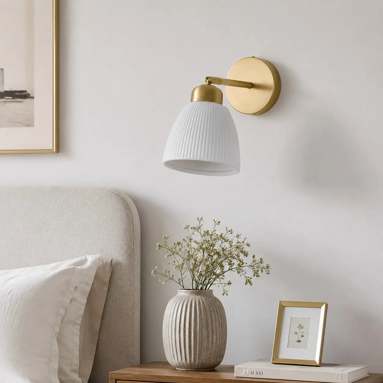 Ceramic wall light above a styled bedroom console