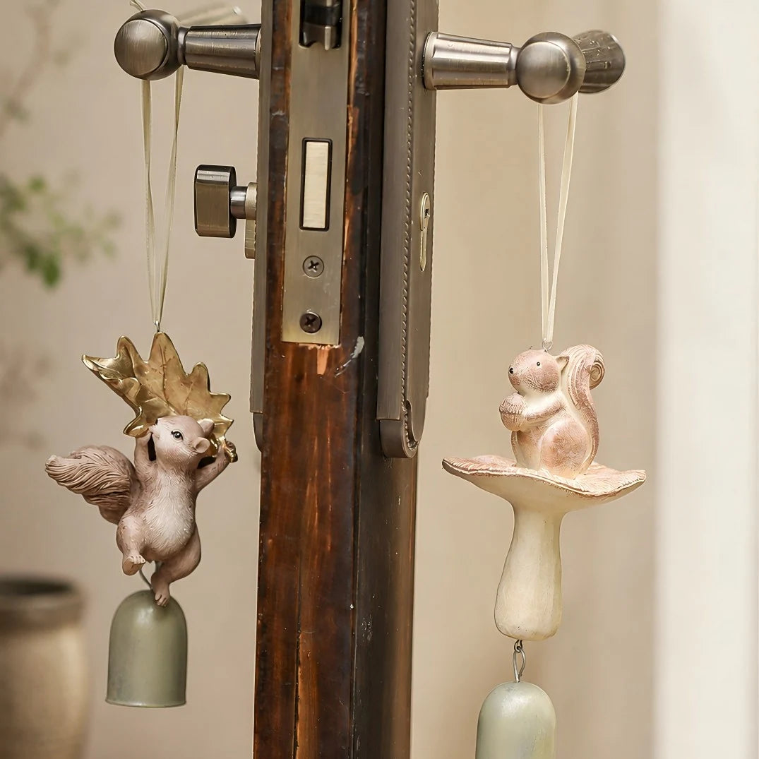 Two warm ivory squirrel wind chime styles hanging on a handle