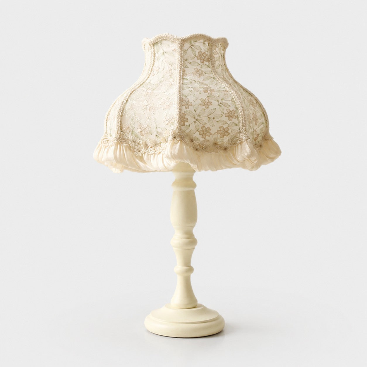 Pearl lace fabric table lamp on a light background