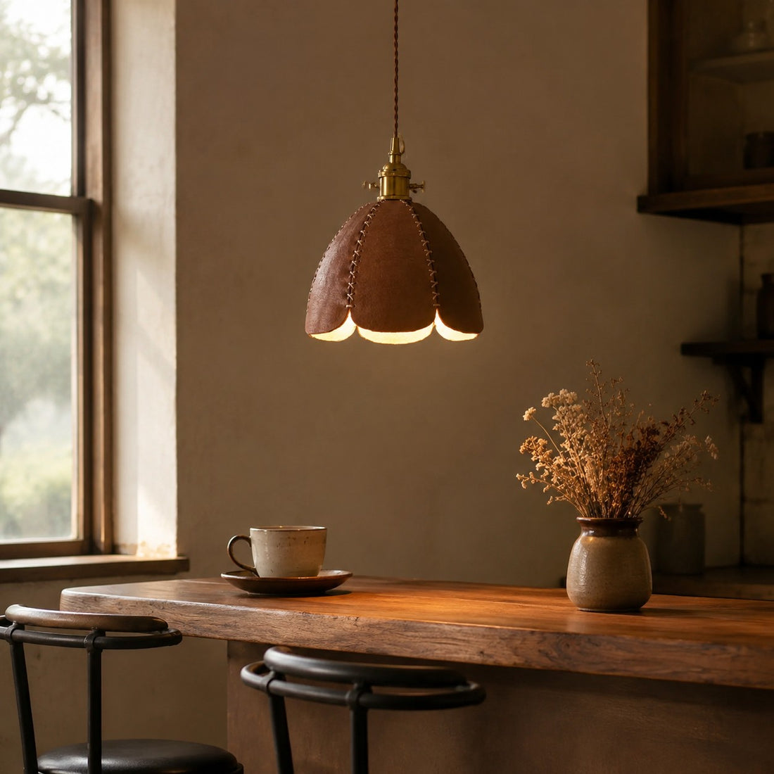 Brown leather petal pendant light above a warm desk corner