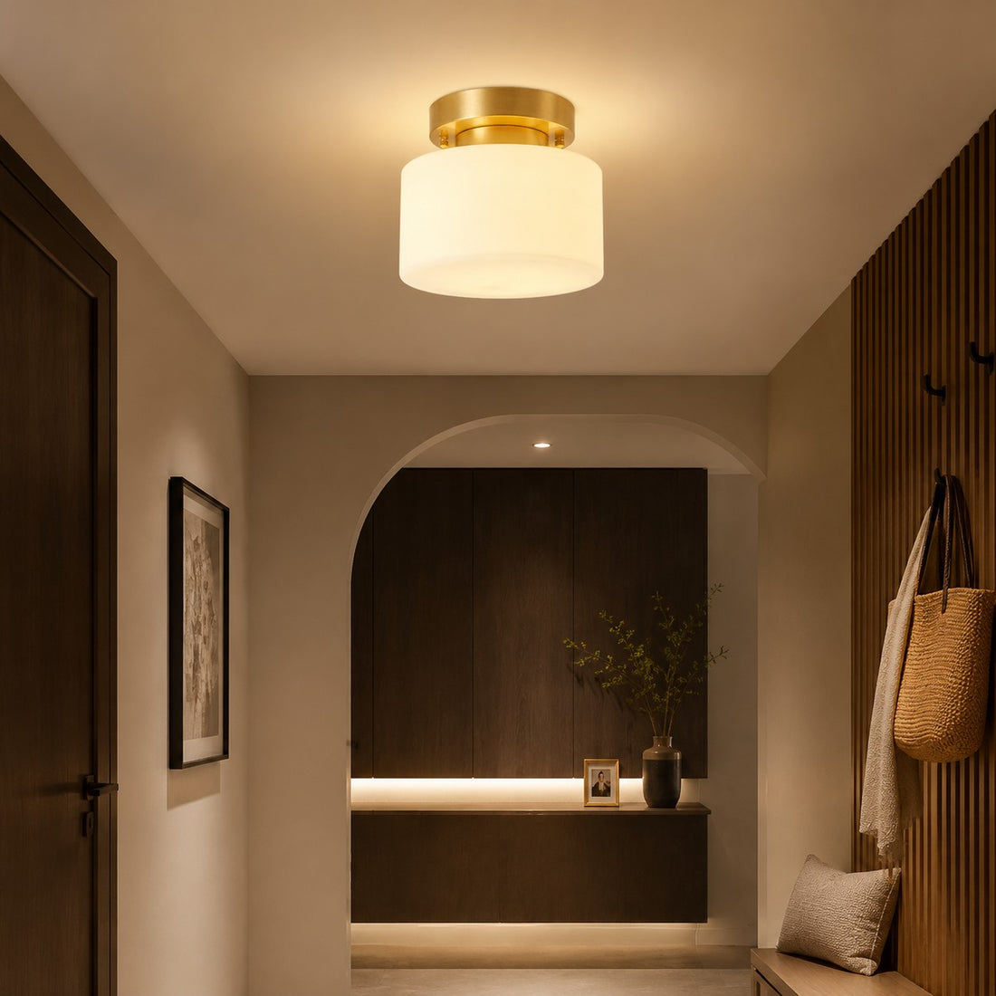Low-profile brass ceiling light illuminating a corridor