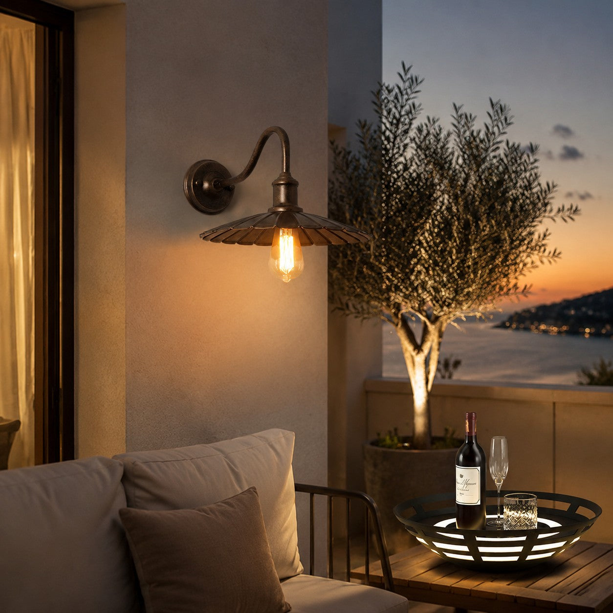 Outdoor wall sconce on a terrace wall at dusk