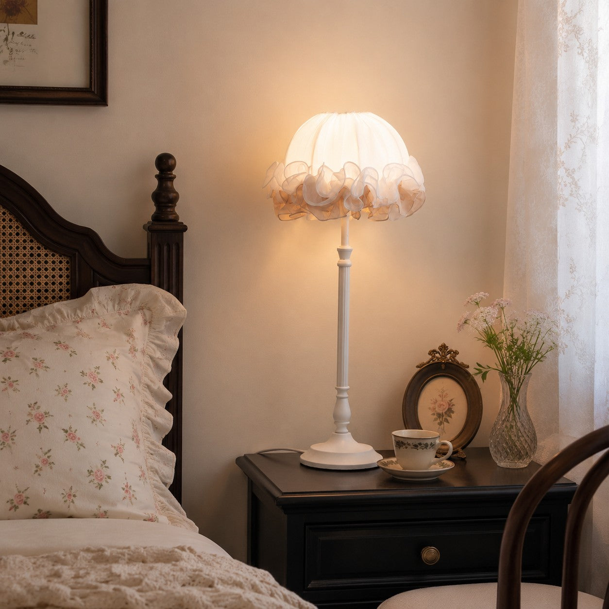 Ruffled table lamp glowing on a dark wood nightstand beside a vintage bed