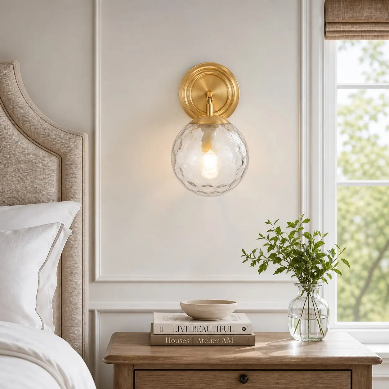 Pair of gold and rippled glass wall lamps in a bedroom